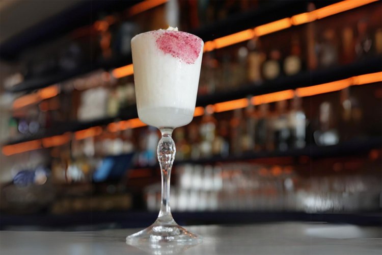 Frozen lemonade cocktail served up in front of a bar