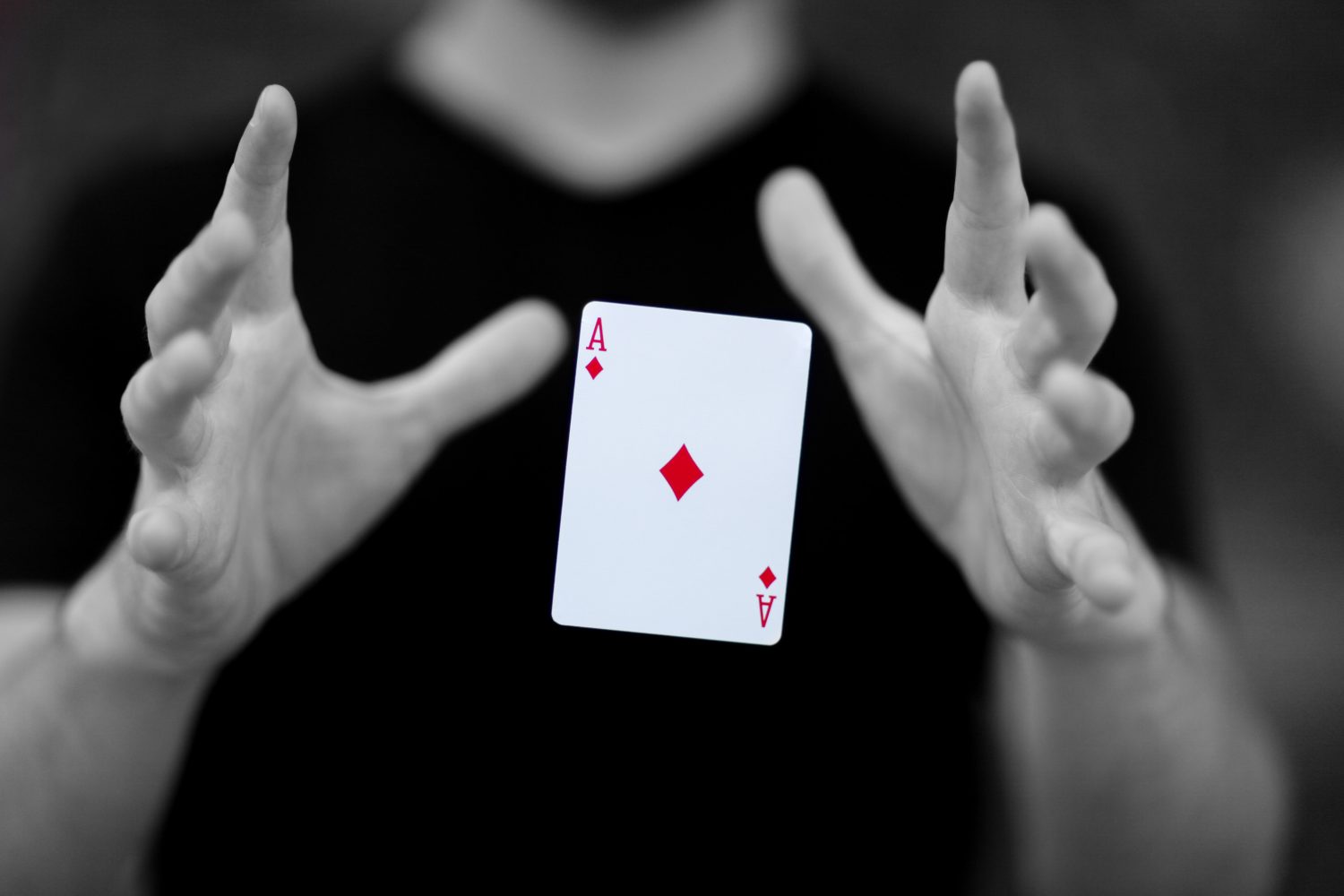 Magician levitating a card magically though mid-air